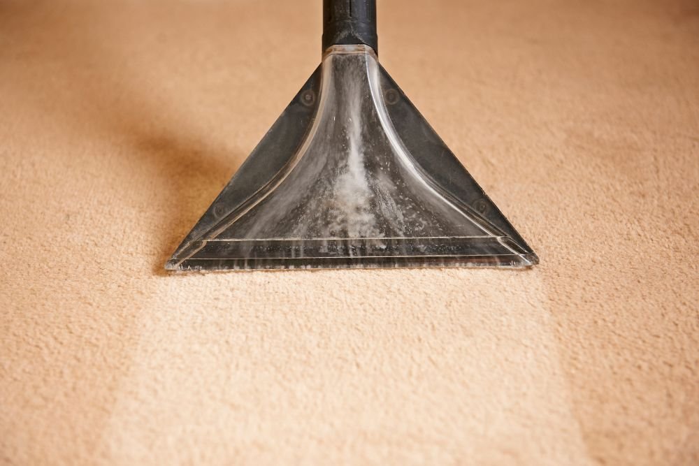 A vacuum cleaner operates on a carpet, highlighting a restoration service located in Columbia, SC.